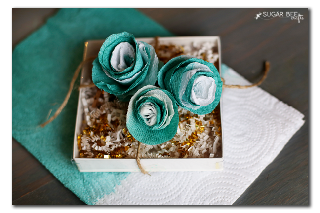 https://sugarbeecrafts.com/wp-content/uploads/2015/12/paper-towel-flowers-gift-wrap-topper.png
